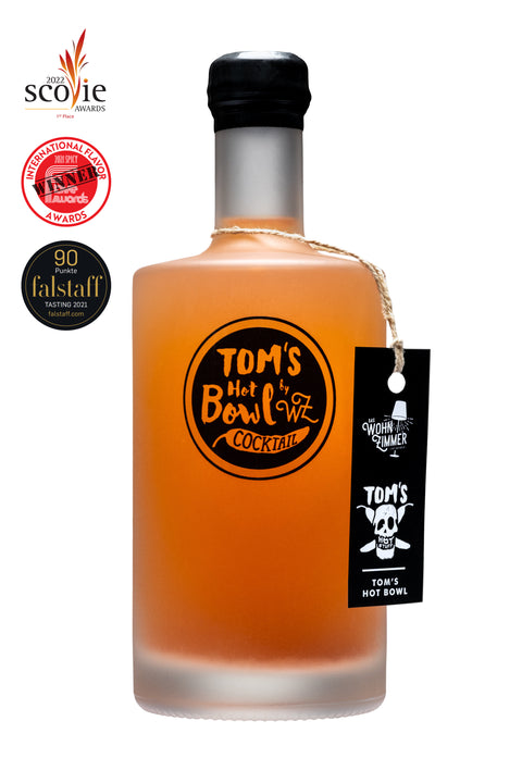 Flasche „TOM'S HOT BOWL Cocktail" mit rotem Inhalt auf weißem Hintergrund, umgeben von drei Auszeichnungen für Geschmack und Schärfe.